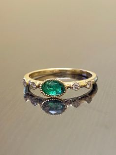 DeKara Designs Collection Our latest design! An elegant and lustrous Colombian and Diamond ring. Metal- 18K Yellow Gold, .750. Stones- Genuine Oval Colombian Emerald, 0.47-0.50 Carats, 6 x 4 MM, 4 Round Diamonds G Color VS2 Clarity 0.05 Carats. Latest of my creations! A Beautiful Minimalist Five Stone Emerald Diamond Engagement Ring Made in 18K Yellow Gold. The ring features a beautiful green oval Colombian Emerald that is professionally bezel set East to West. There are two burnish set round di Emerald Diamond Engagement Ring, Gold Minimalist Ring, Emerald Ring Engagement Diamond, Emerald Wedding Rings, Opal Wedding Rings, Emerald Wedding, Green Oval, Colombian Emeralds, Minimalist Ring