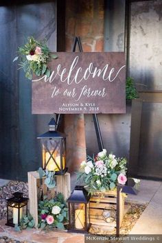 a welcome sign with flowers and candles on it