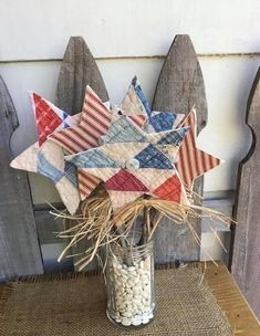 a vase filled with marshmallows and an american flag pinwheel