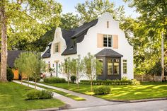 a white house with black roof and windows