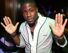 a man standing in front of a crowd holding his hands up to the camera with both hands