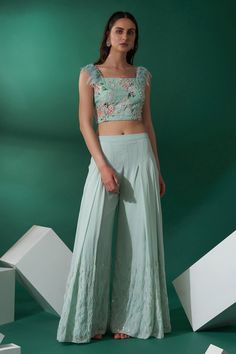 Sea green crop top with floral motif embroidery and feather embellished straps. Paired with embroidered hem pant. Component: 2 Pattern: Embroidered Type Of Work: Floral Motifs Neckline: Square Sleeve Type: Sleeveless Fabric: Soft Organza, Georgette Crepe Color: Green Other Details:  Feather embellished straps Front pleated pant Occasion: Mehendi and Haldi - Aza Fashions Palazoo Sets Crop Tops, Plazo Outfits, Off Shoulder Lehenga, Plazo Designs, Top And Plazo, Crop Top And Pants Set, Animation Wallpaper, Crop Top Lehenga, Haldi Outfit