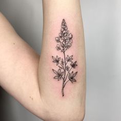 a black and white flower tattoo on the arm