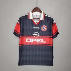 a soccer jersey hanging on a hanger with the word opel printed on it