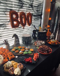 a table topped with lots of halloween treats