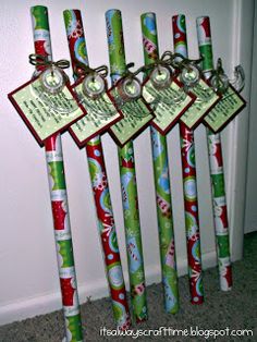 four christmas themed toothbrushes with tags attached to them, all decorated in green and red