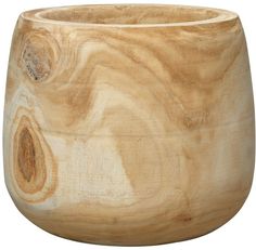 a wooden bowl sitting on top of a white surface