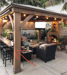 an outdoor living area with patio furniture and lights on the ceiling, covered in wood