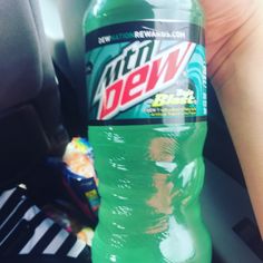 a bottle of mountain dew sitting in the passenger seat