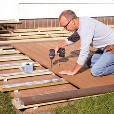 a man working on a deck with tools