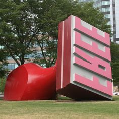 a giant red heart shaped object in front of a large pink sign that says intel