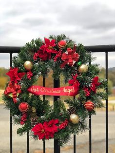 a christmas wreath is hanging on a gate