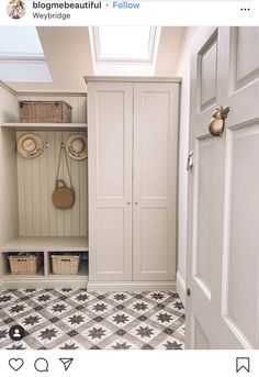 a white closet with two doors and baskets on the door handle, next to a black and white checkered floor