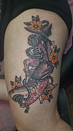 a woman's thigh with tattoos on it