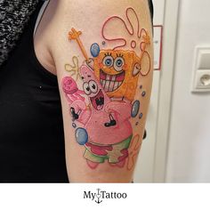 a person with a tattoo on their arm and the image of spongebob holding a key