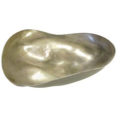 a large metal bowl sitting on top of a white surface