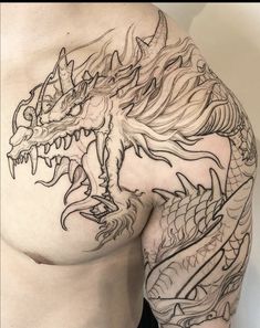 a man's chest with a dragon tattoo on his left side and the upper part of his stomach