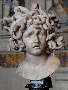 a marble bust of a woman with curly hair