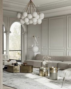 an elegant living room with white walls and gold accents