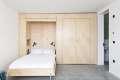 a bed sitting in the middle of a bedroom next to two closets on either side of it