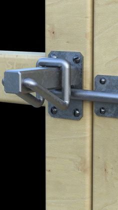 a close up of a metal latch on a wooden door