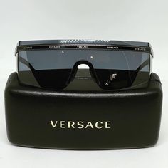 Women’s Black Rimless Shield Sunglasses By Versace. Brand Name Repeats In Gold Lettering Across Temples. Nose Piece For Added Comfort. Designer Case Included Black Rimless Shield Sunglasses For Party, Black Rimless Sunglasses For Formal Occasions, Formal Black Shield Sunglasses With Uva Protection, Black Shield Sunglasses With Uva Protection For Formal Occasions, Designer Black Rimless Sunglasses, Designer Shield Sunglasses With Uv Protection For Evening, Versace Brand, Nose Piece, Versace Accessories