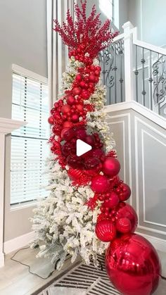 a red and white christmas tree decorated with ornaments