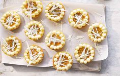 small appetizers are arranged on a white tray