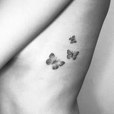 three butterflies on the side of a woman's stomach