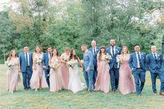 a group of people standing next to each other on top of a lush green field