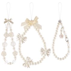 three necklaces with bows and pearls on them