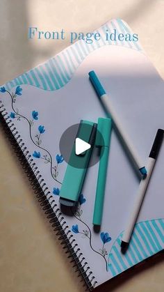 a notebook with two pens on it and the words front page ideas written in blue