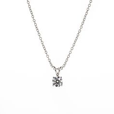 There's something classic and luxurious about a high quality single diamond hanging around your neck. This diamond solitaire pendant necklace is made from solid platinum and measures 18" long. The diamond is GIA certified as an all-natural .92ct G/VS2 round brilliant cut diamond securely set in a four prong basket style setting. This necklace comes with the GIA certificate and a free official appraisal showing the value of the necklace at $9650. Timeless Solitaire Pendant Necklace In Brilliant Cut, Timeless Solitaire Pendant Necklace With Brilliant Cut, Timeless Solitaire Necklace With Brilliant Cut Pendant, Classic Single Diamond Necklace, Lab Grown, Timeless Silver Solitaire Necklace With Single Diamond, Classic Necklace With Single Lab Grown Diamond, Classic Necklace With Single Lab-grown Diamond, Silver Platinum Solitaire Necklace With Brilliant Cut, Sterling Silver Solitaire Necklace With Tension Setting