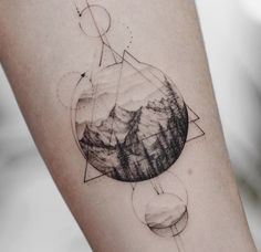 a tattoo on the arm of a person with mountains in the background and an arrow