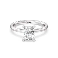 a white gold ring with a princess cut diamond