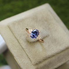 a tan and blue ring sitting on top of a box