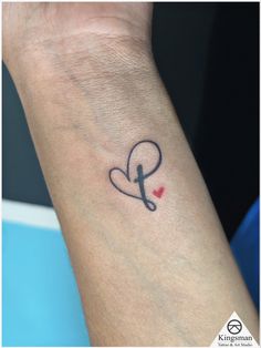 a person's arm with a tattoo on it and a heart in the middle