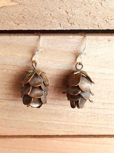 "Perfectly Cute Pine Cone Earrings These Little Cuties are Completely Hand Built from sheet metal and wire, not cast!  One of my masterpieces, I am very proud of them :) Oxidized (antiqued) Copper or Sterling Silver with a bit of Brass at the top of the pine cone hanging on hand twisted sterling silver ear wires, very realistic These earrings are modeled after the Hemlock Cone, and are life size at about 3/4\" long, the earring is about 1\" from the top of the sterling silver ear wire to the bot Pine Cone Earrings, Pinecone Earrings, Pine Cone Jewelry, Cowgirl Necklaces, Brass Pendant Necklace, Jewelry Rustic, Rustic Earrings, Earrings Nature, Mixed Metal Earrings