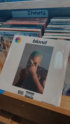 the album blond is on display in front of other cds and cdshelves at a store