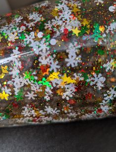 a close up of a shiny object with snowflakes and stars on the surface