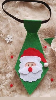 a green neck tie with a santa clause on it and snowflakes in the background