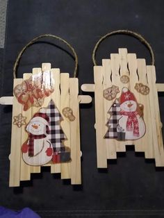 two wooden sleds with snowmen on them