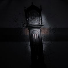 an old grandfather clock sitting in the corner of a room with no one around it