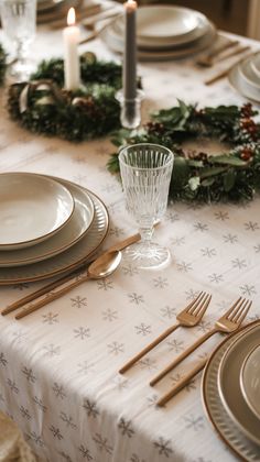 the table is set for christmas dinner with silverware