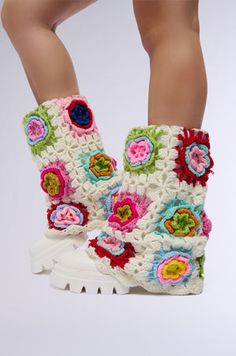 a woman's legs wearing white crocheted boots with colorful flowers on them