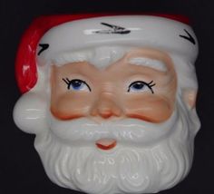 a close up of a santa claus head on a black background