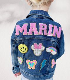 This custom patch denim jacket is perfect for the trendy kid in your life! Show off all their favorite things in style! ALL PATCHES ARE SEWN ON TO RE-ENFORCE AND EXTEND WEAR! **Denim sizes RUN SMALL so please ORDER ONE SIZE UP Each jacket is MADE TO ORDER and READY TO SHIP IN 3-10 Business Days! Letter Patch Options: ✨MULTI-COLOR CHENILLE (PINK, BLUE, WHITE, & PURPLE) ✨PINK/GOLD CHENILLE ✨PURPLE/GOLD CHENILLE ✨MINT/GOLD CHENILLE ✨WHITE/GOLD CHENILLE ✨BLACK/GOLD CHENILLE PERSONALIZATION: 1. SELECT the size from drop down menu. 2. SELECT the amount of patches from the drop down menu.  3. ENTER name and COLOR of LETTERS in the Personalization Box. 4. SELECT PATCHES from listed patches. (If you are looking for specific patches, please send me a message) 5. Patch placement is completed by desig Name Jean Jacket, Disney Patch Jean Jacket, Crucit Ideas, Denim Patch Jacket, Celine Brand, Jean Jacket Patches, Custom Jean Jacket, Kids Denim Jacket, Girl Patches