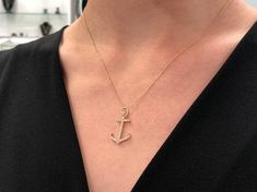 This is our gorgeous gold and diamond anchor. Set sail with this spectacular diamond piece. Diamonds are pave set in smooth, silky gold. The size on this pendant/charm is ideal, big enough to notice without being overwhelming. This nautical-inspired fashion pendant is just perfect for a lady who loves the open sea. Perfect for layering as well! Stone: Diamond Shape: Brilliant Round Weight: 0.30pts Clarity: VS Color: Near Colorless Luster: Excellent Cut: Excellent Natural Diamond Setting: Pave Se Elegant Yellow Gold Anchor-shaped Necklaces, Anchor Pendant Gold, Anchor Pendant, Anchor Charm, Anchor Necklace, Fashion Pendant, Nautical Anchor, Necklace Diamond, Colombian Emeralds