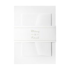 the wedding stationery is shown in white with gold foil lettering and a matching envelope