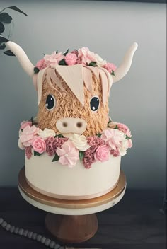 a cake decorated with flowers and a cow head